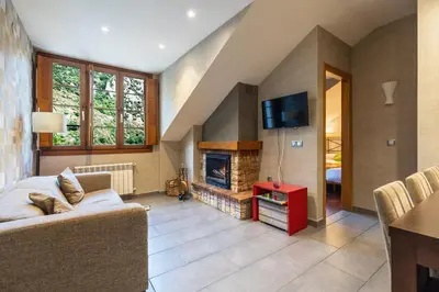 a living room with a couch and a fireplace at Apartamentos Casa Miño in Pola de Somiedo