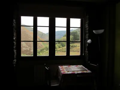 a room with a window with a table and a view at Luna de Vilar in Vilarpescozo