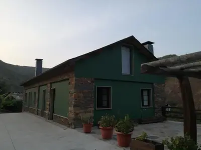 a green house with potted plants in front of it at Luna de Vilar in Vilarpescozo
