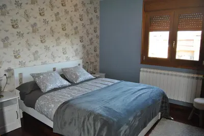 a bedroom with a bed and a window at Casa Loisiana in O Pino