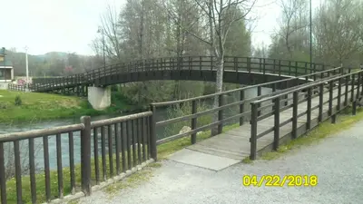 a bridge over a river with a wooden walkway at Casa los Ancares in Vega de Espinareda