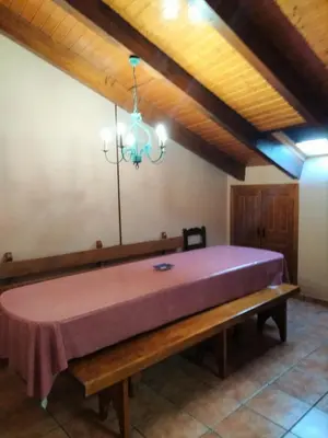 a large purple bed in a room with a wooden ceiling at Casa los Ancares in Vega de Espinareda
