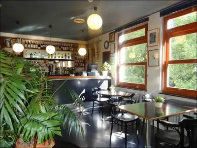 a restaurant with tables and chairs and a bar at Hotel Restaurante Marroncín in Cangas del Narcea