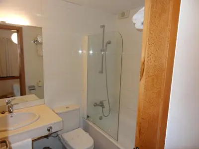 a bathroom with a shower and a toilet and a sink at Hotel Restaurante Marroncín in Cangas del Narcea