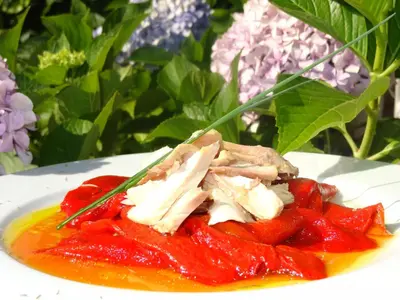 a plate of food with chicken and strawberries on it at Hotel Restaurante Marroncín in Cangas del Narcea
