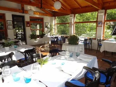 a dining room with white tables and chairs at Hotel Restaurante Marroncín in Cangas del Narcea