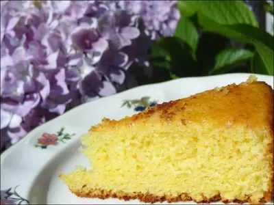 a piece of cake on a white plate with purple flowers at Hotel Restaurante Marroncín in Cangas del Narcea