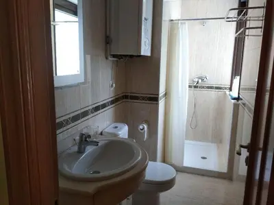 a bathroom with a sink and a toilet and a shower at María Belkis ll in Ourense