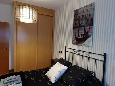 a bedroom with a bed and a picture of a boat at María Belkis in Ourense