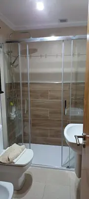 a bathroom with a shower and a toilet and a sink at María Belkis in Ourense