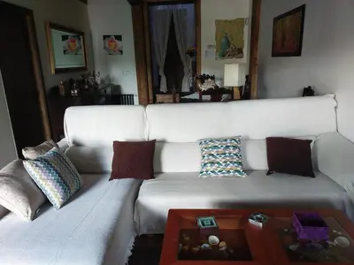 a white couch with pillows and a coffee table at La casita de la señora María in Ponferrada