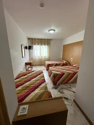a room with two beds in a room at P Residencia PIVIDAL in Picaraña