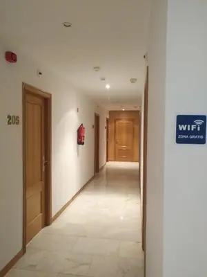 an empty hallway with a sign on the wall at P Residencia PIVIDAL in Picaraña