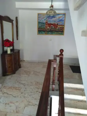 a staircase in a room with a painting on the wall at P Residencia PIVIDAL in Picaraña