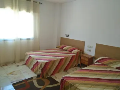 two twin beds in a room with a window at P Residencia PIVIDAL in Picaraña