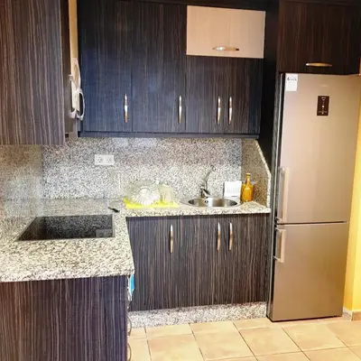a kitchen with a sink and a refrigerator at Moreiriña- Bentraces in Bentraces