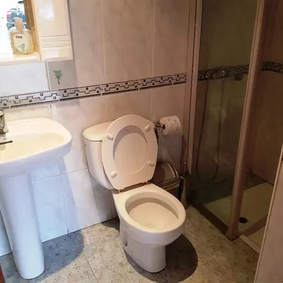 a bathroom with a toilet and a sink and a shower at Moreiriña- Bentraces in Bentraces