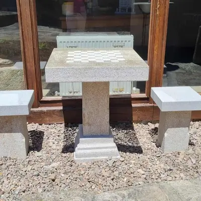 a table and two benches in front of a window at Pazo de Eidian in Eidián