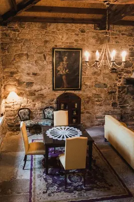 a dining room with a table and chairs at Pazo de Eidian in Eidián