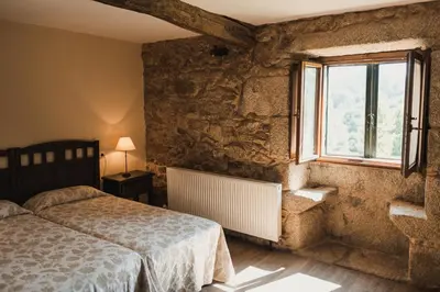 a bedroom with a bed and a window at Pazo de Eidian in Eidián