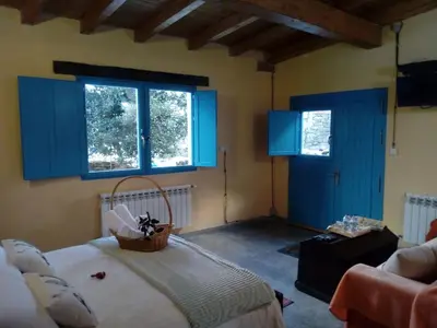 a room with blue doors and a basket on a bed at Casa Antoni@ in Parada del Sil