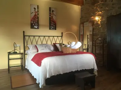 a bedroom with a bed with a basket on it at Casa Antoni@ in Parada del Sil