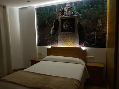 a bedroom with a bed and a picture on the wall at Camiño Portugues in Padrón