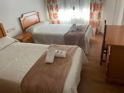 a hotel room with two beds with towels on them at Camiño Portugues in Padrón