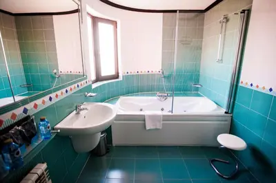 a blue bathroom with a tub and a sink at Motel Venus Santiago in Luou