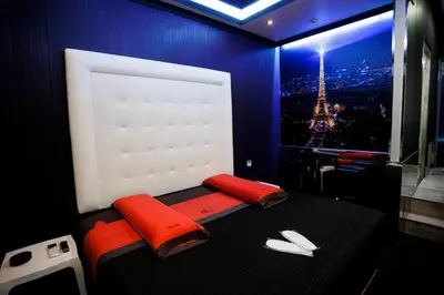 a room with a bed with a view of the eiffel tower at Motel Venus Santiago in Luou