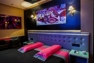 a room with a bed and a tv on the wall at Motel Venus Santiago in Luou