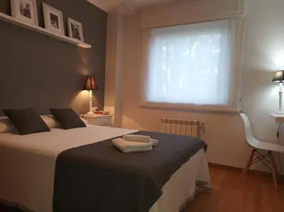 a bedroom with a bed with two towels on it at Descanso do Sar in Santiago de Compostela