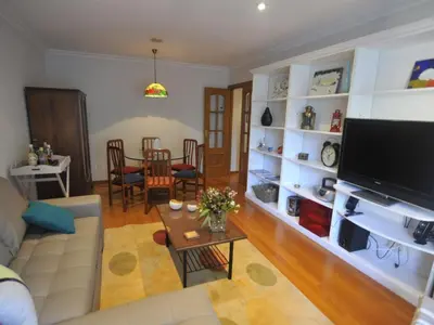a living room with a couch and a table at Descanso do Sar in Santiago de Compostela