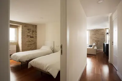 a bedroom with two beds and a room with at Luxury apartment-free parking in Santiago de Compostela