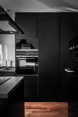 a kitchen with black cabinets and an oven at Luxury apartment-free parking in Santiago de Compostela