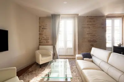 a living room with a white couch and a glass table at Luxury apartment-free parking in Santiago de Compostela