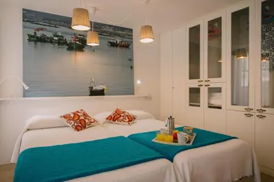 a bedroom with a bed with a tray on it at roomPEDRA apartamentos turísticos in Santiago de Compostela