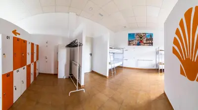 a room with a hallway with orange and white walls at Albergue Espiritu Xacobeo in O Pedrouzo