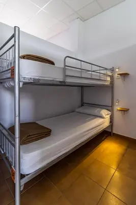 a couple of bunk beds in a room at Albergue Espiritu Xacobeo in O Pedrouzo