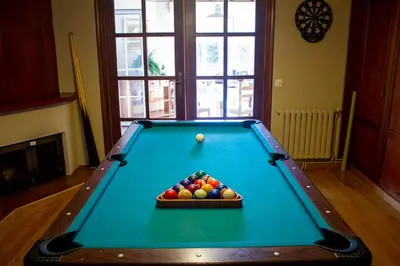 a pool table with a bowl of balls on it at Villa Salgueiros in Teo