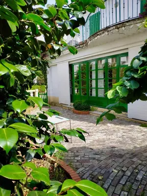 a patio with a bench in front of a building at Covas Seabreeze Cottage in Viveiro