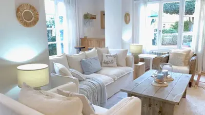 a living room with a white couch and a table at Covas Seabreeze Cottage in Viveiro