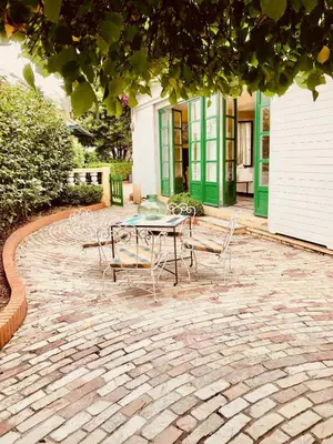 a table and chairs on a brick patio at Covas Seabreeze Cottage in Viveiro