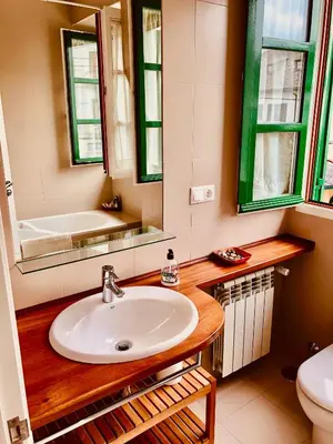 a bathroom with a sink and a toilet and a mirror at Covas Seabreeze Cottage in Viveiro
