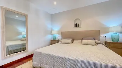 a bedroom with a bed and a large mirror at Covas Seabreeze Cottage in Viveiro