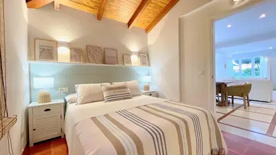 a bedroom with a bed and a dining room at Covas Seabreeze Cottage in Viveiro