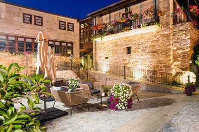 a patio with chairs and umbrellas in front of a building at Pazo de Esposende in Esposende