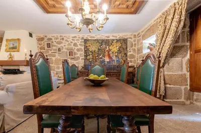 a dining room with a wooden table and green chairs at Pazo de Esposende in Esposende
