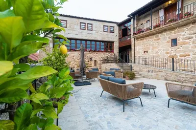 a patio with chairs and tables in front of a building at Pazo de Esposende in Esposende