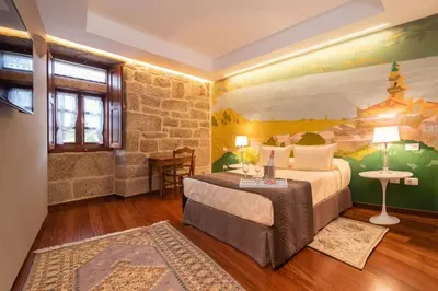 a bedroom with a king sized bed in a room at Pazo de Esposende in Esposende